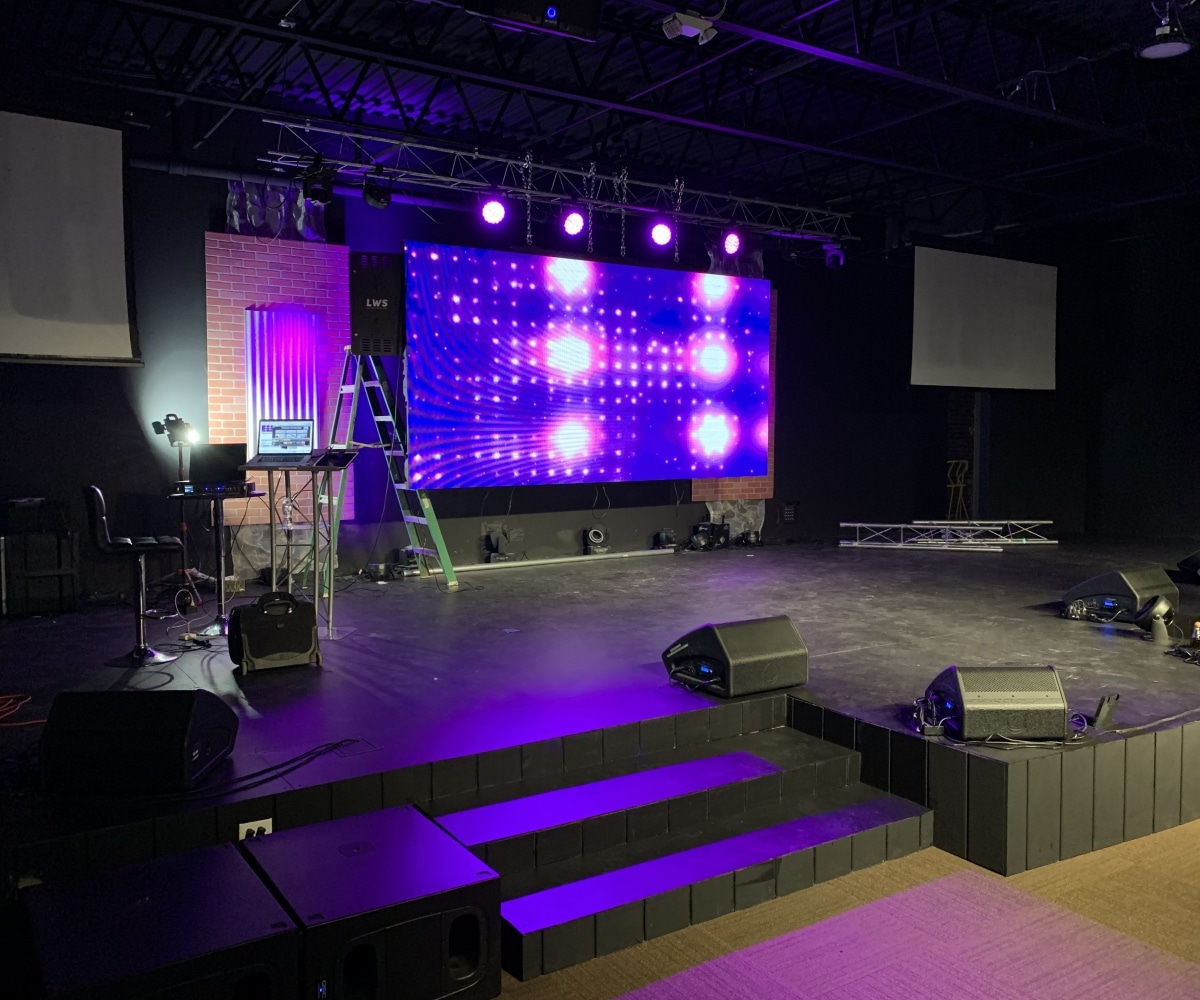 A stage illuminated with purple lighting, creating a vibrant atmosphere for a performance or event.